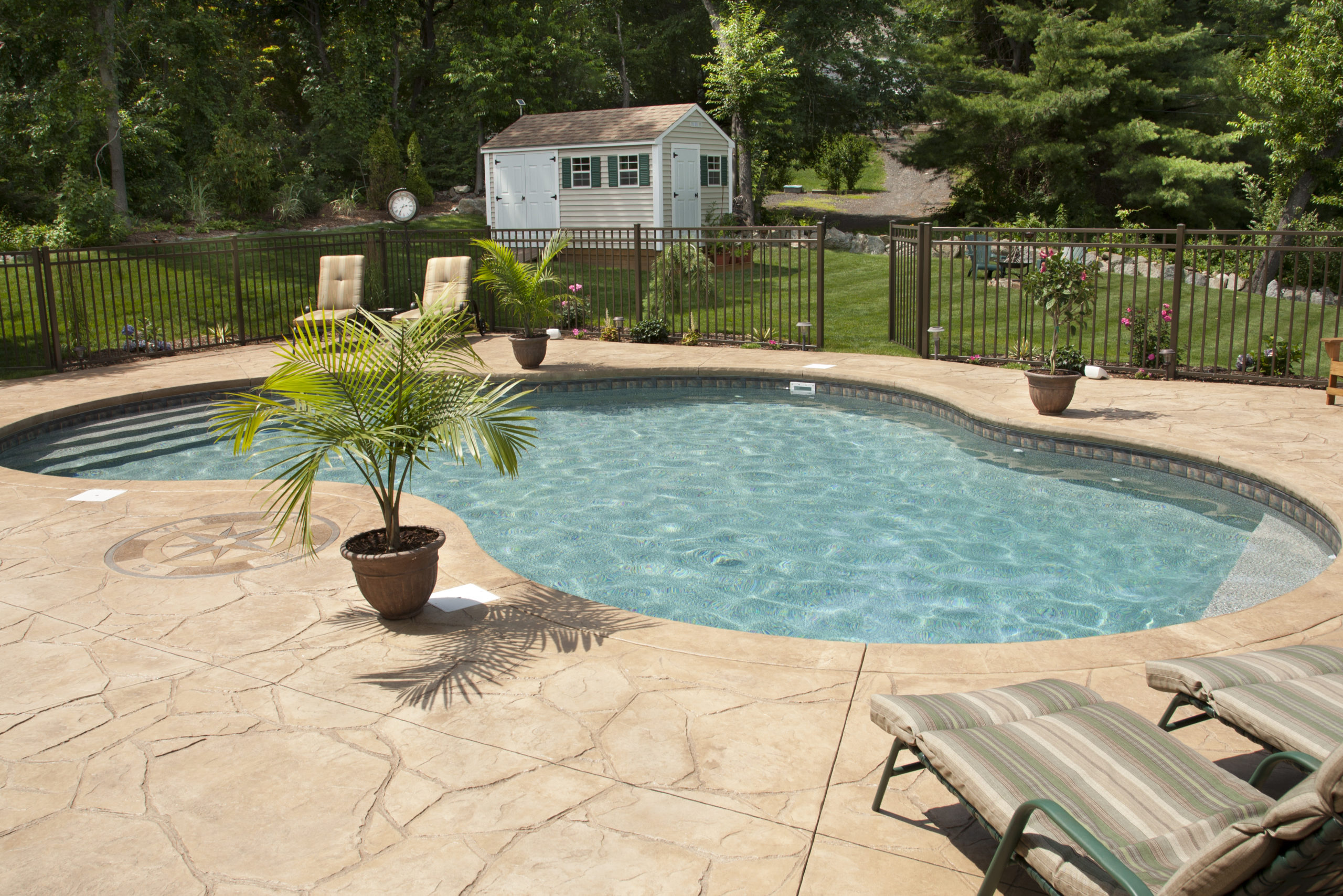 This is an image of a stamped concrete pool deck on a residential property.